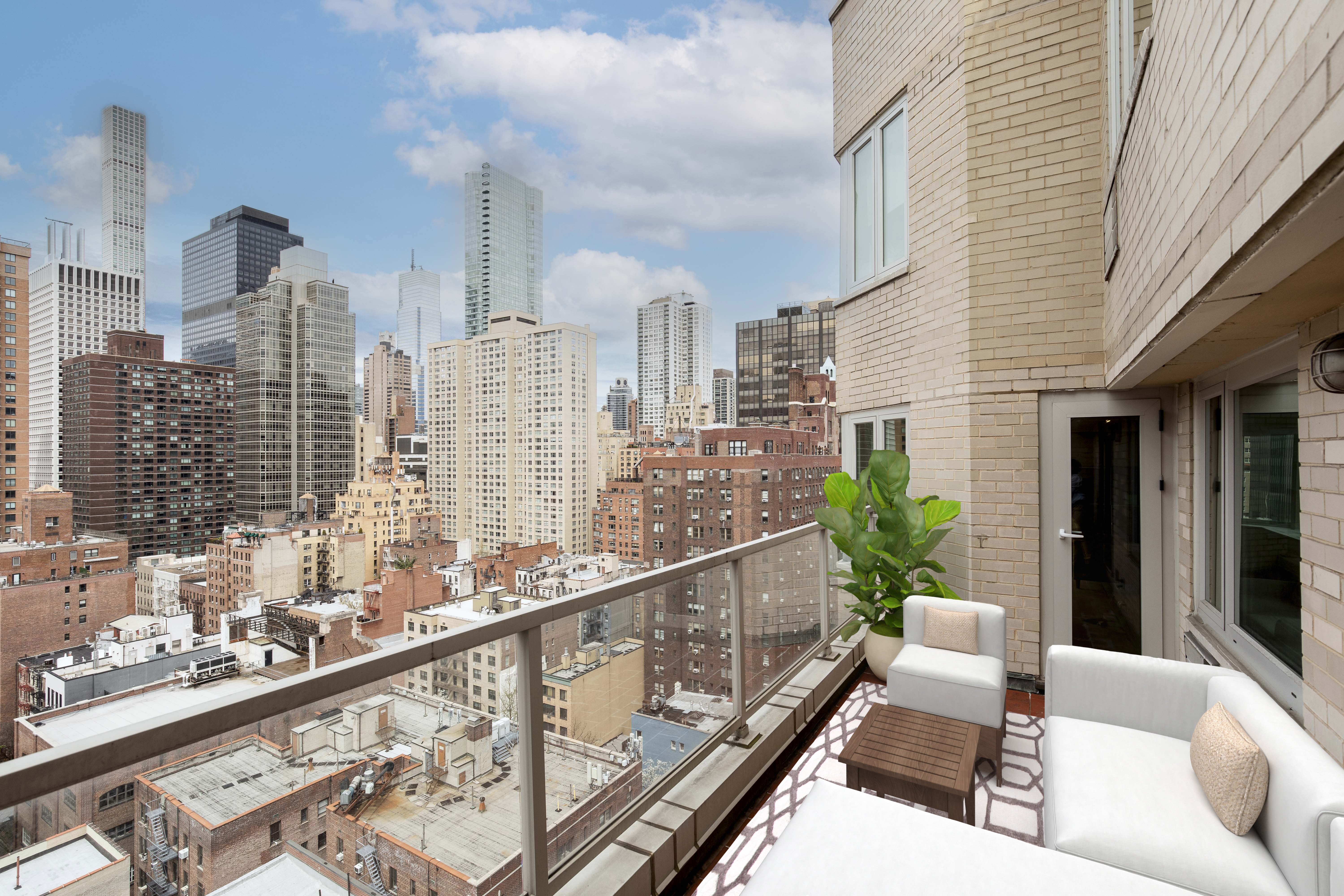 411 East 53rd Street, Unit 19D Manhattan, NY 10022 - Photo 7 of 13 a balcony with furniture and a potted plant