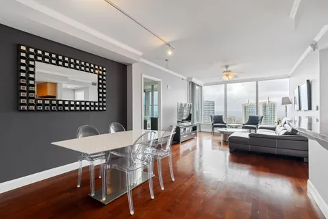 a living room with a large window and a table