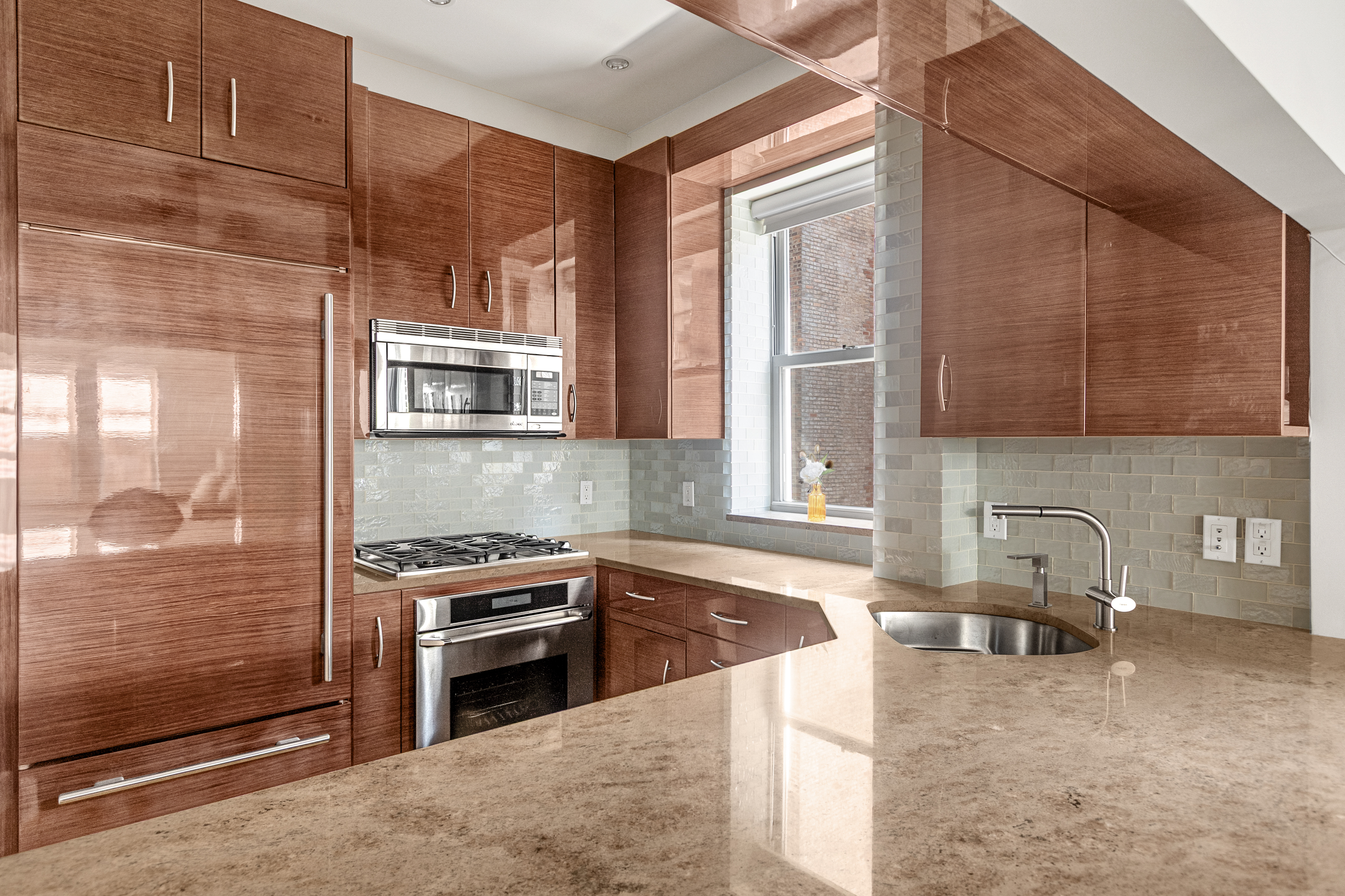 345 West 70th Street, Unit 4E Manhattan, NY 10023 - Photo 3 of 11 a kitchen with granite countertop a sink and a stove top oven