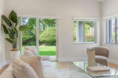 a dining room with furniture a mirror and a chandelier
