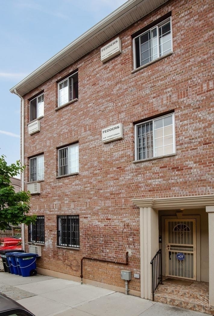 54 Lott Street, Unit 2 Brooklyn, NY 11226 - Photo 8 of 9 a front view of a building with multiple windows