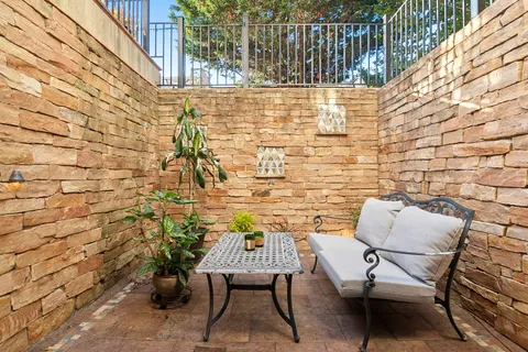 a balcony with table and chairs