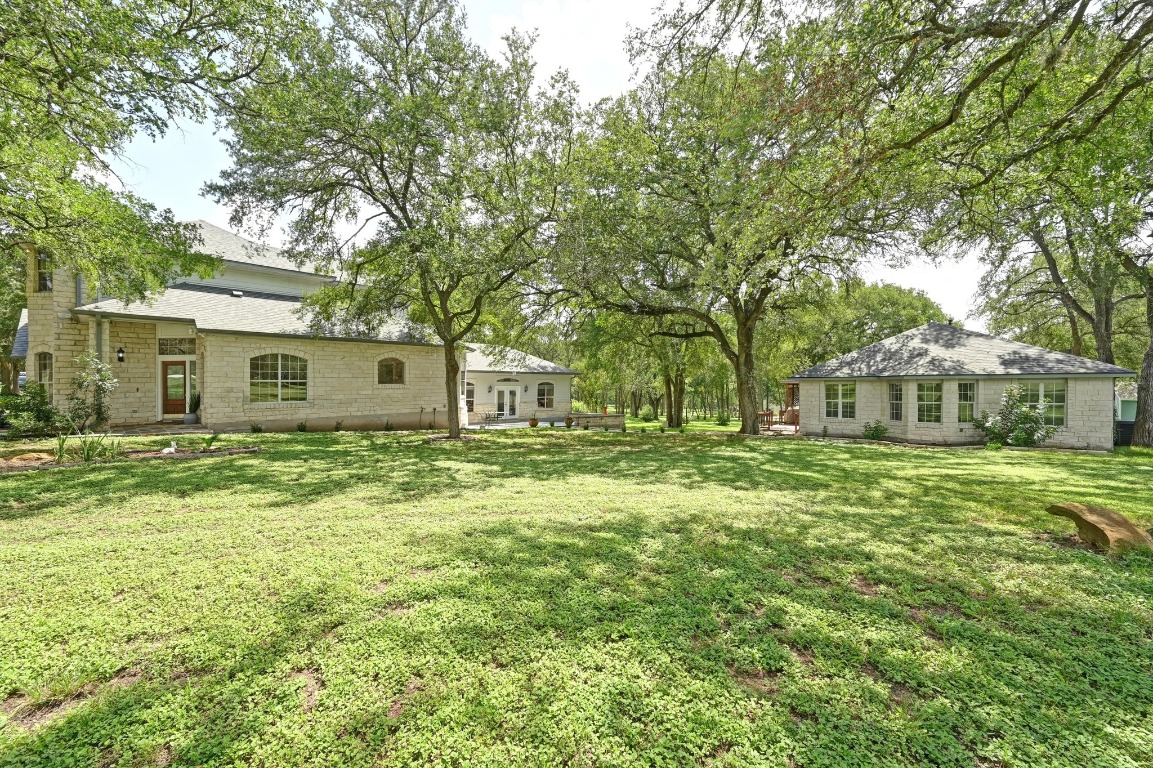 111 Trinity Street Cedar Creek, TX 78612 - Photo 32 of 38 a front view of a house with a garden