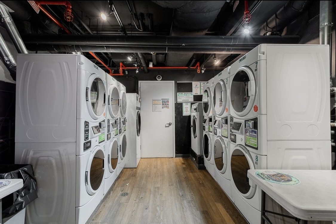 220 East 63rd Street, Unit 4N Manhattan, NY 10065 - Photo 12 of 13 a view of a storage and utility room with washer and dryer