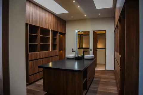 a kitchen with a counter top space and windows