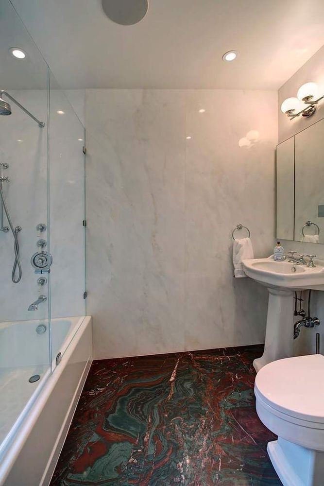 128 Central Park South, Unit 9B Manhattan, NY 10019 - Photo 8 of 11 a bathroom with a sink and a toilet