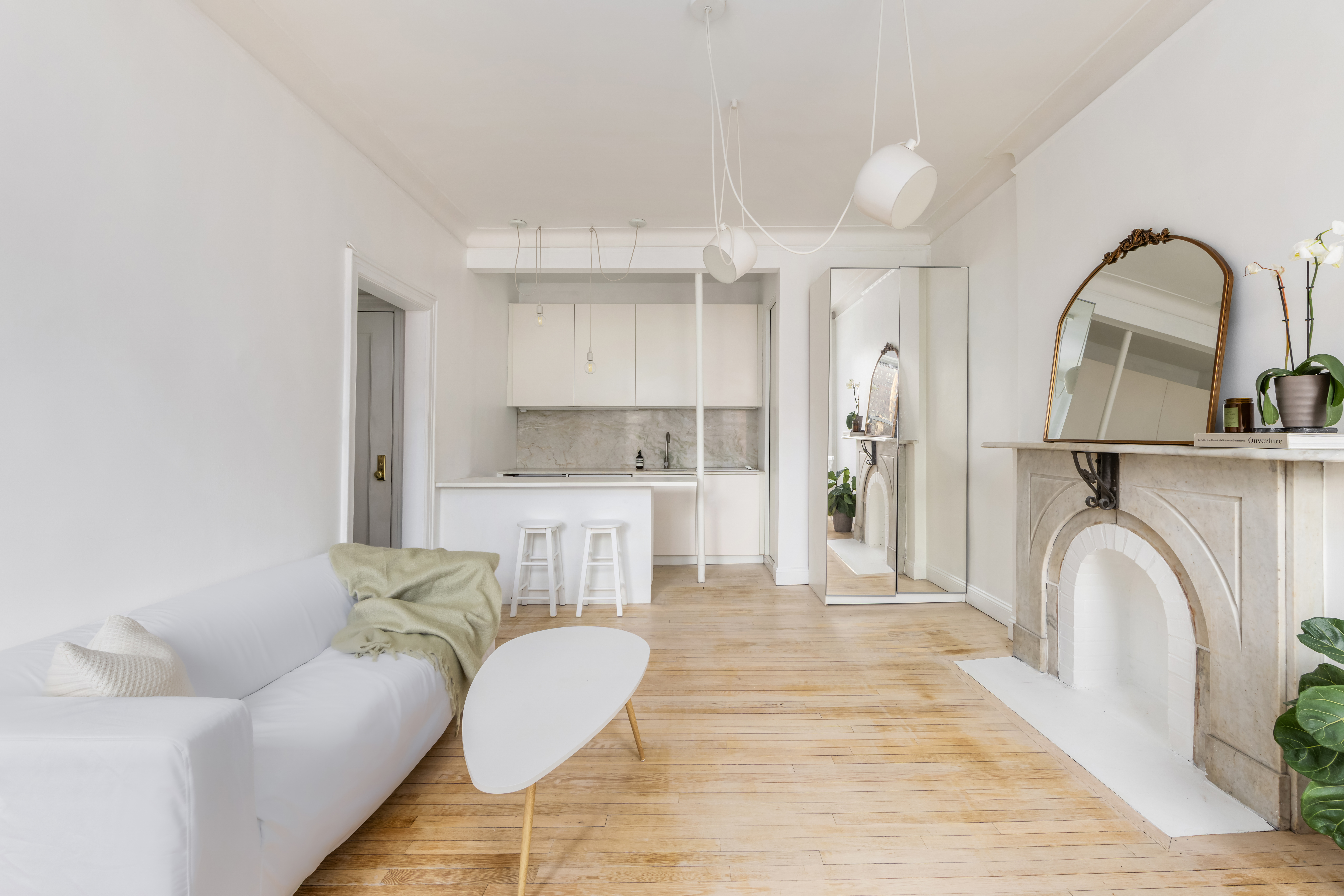 345 West 4th Street, Unit 8 Manhattan, NY 10014 - Photo 2 of 7 a living room with furniture and a fireplace