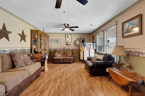 a living room with furniture and a wooden floor
