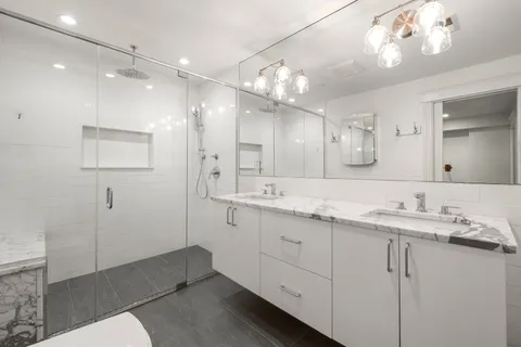 a bathroom with a sink toilet and shower