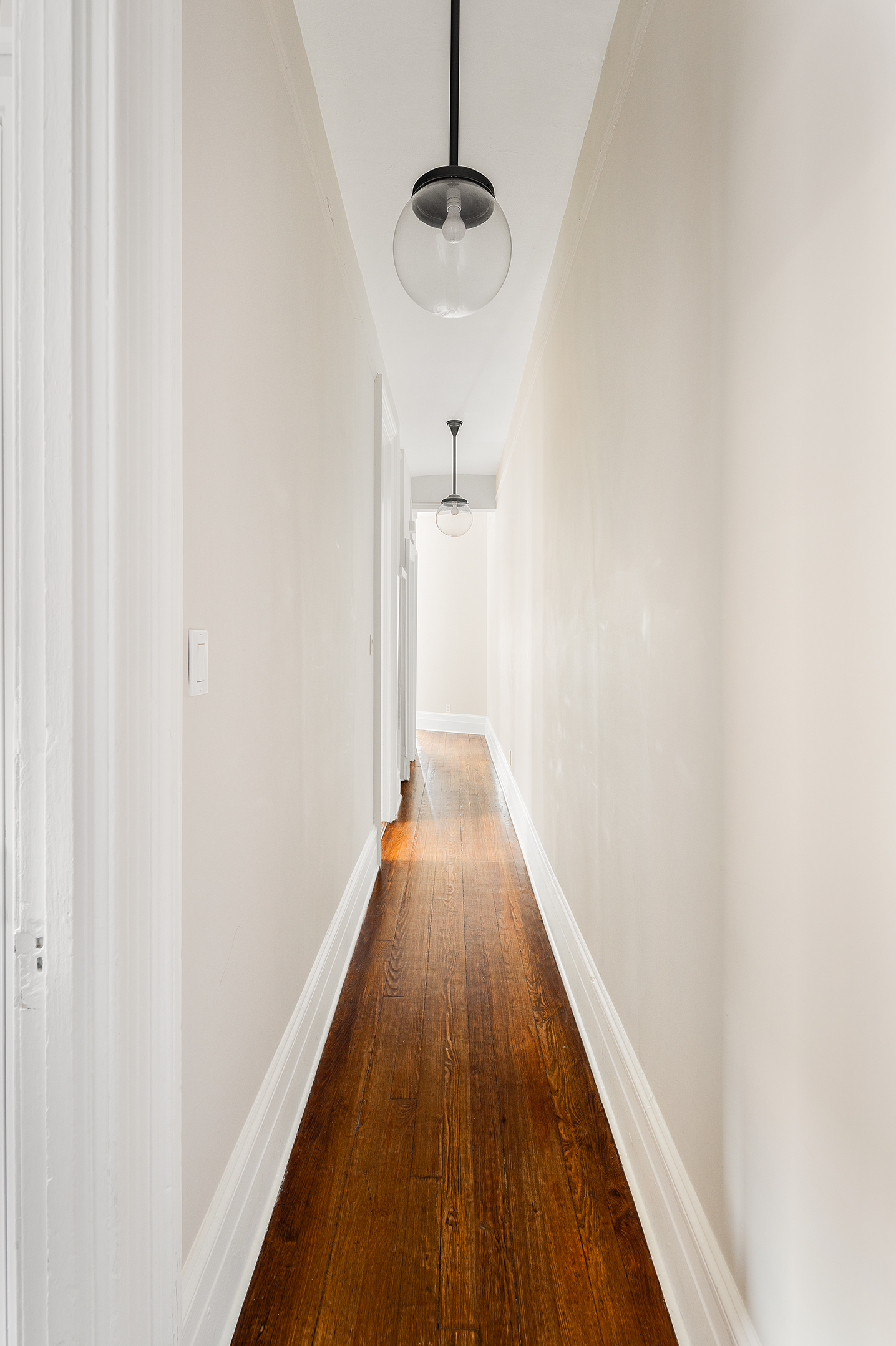 223 West 21st Street, Unit PH5M Manhattan, NY 10011 - Photo 9 of 12 a view of a hallway with wooden floor