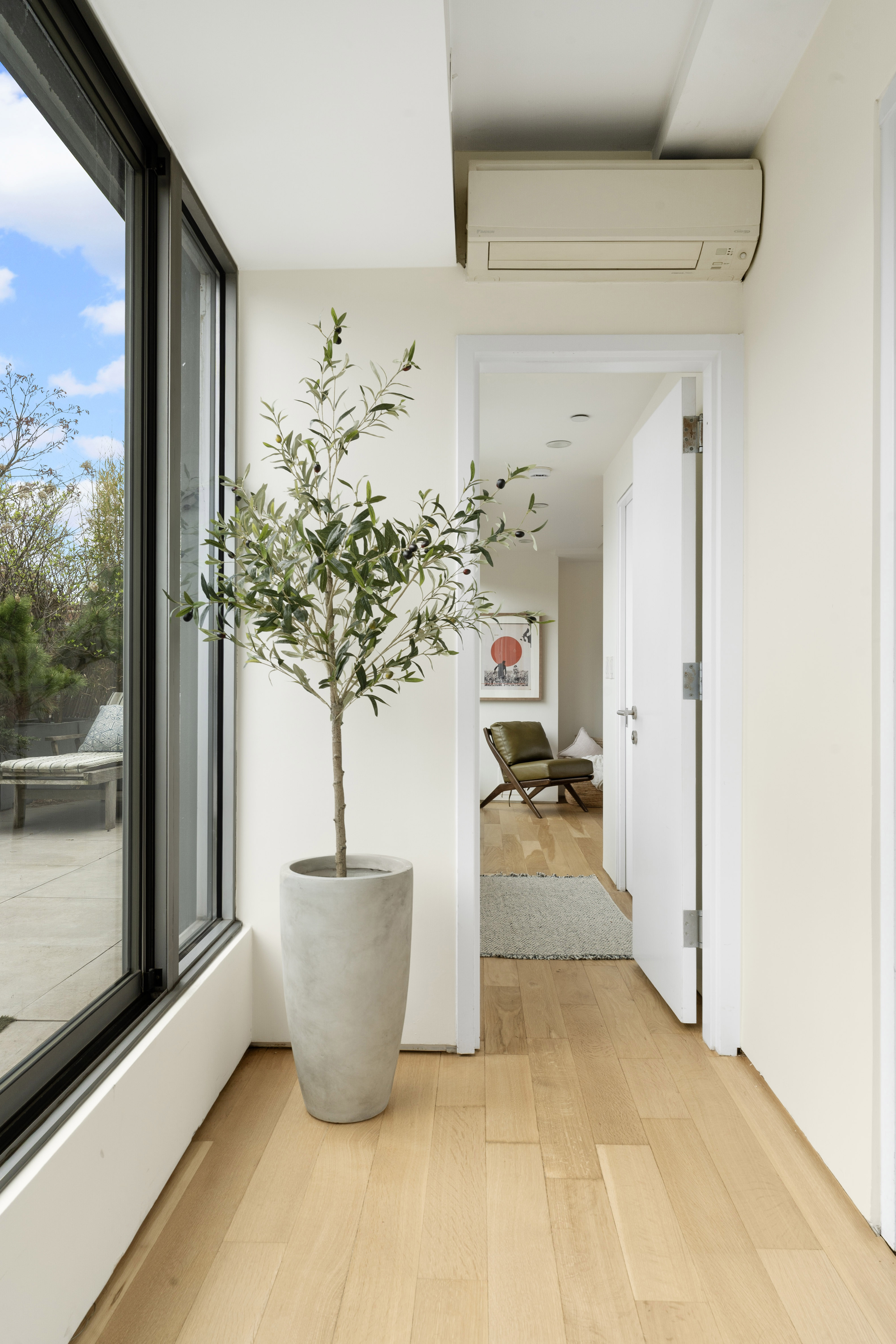 142 North 1st Street, Unit PH Brooklyn, NY 11249 - Photo 6 of 15 a living room with furniture and a potted plant