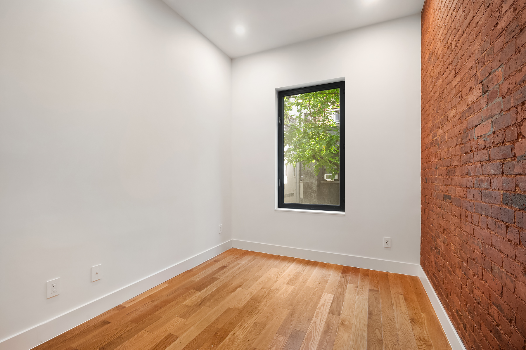 61 West 70th Street, Unit 2B Manhattan, NY 10023 - Photo 5 of 7 a view of an empty room with wooden floor and a window