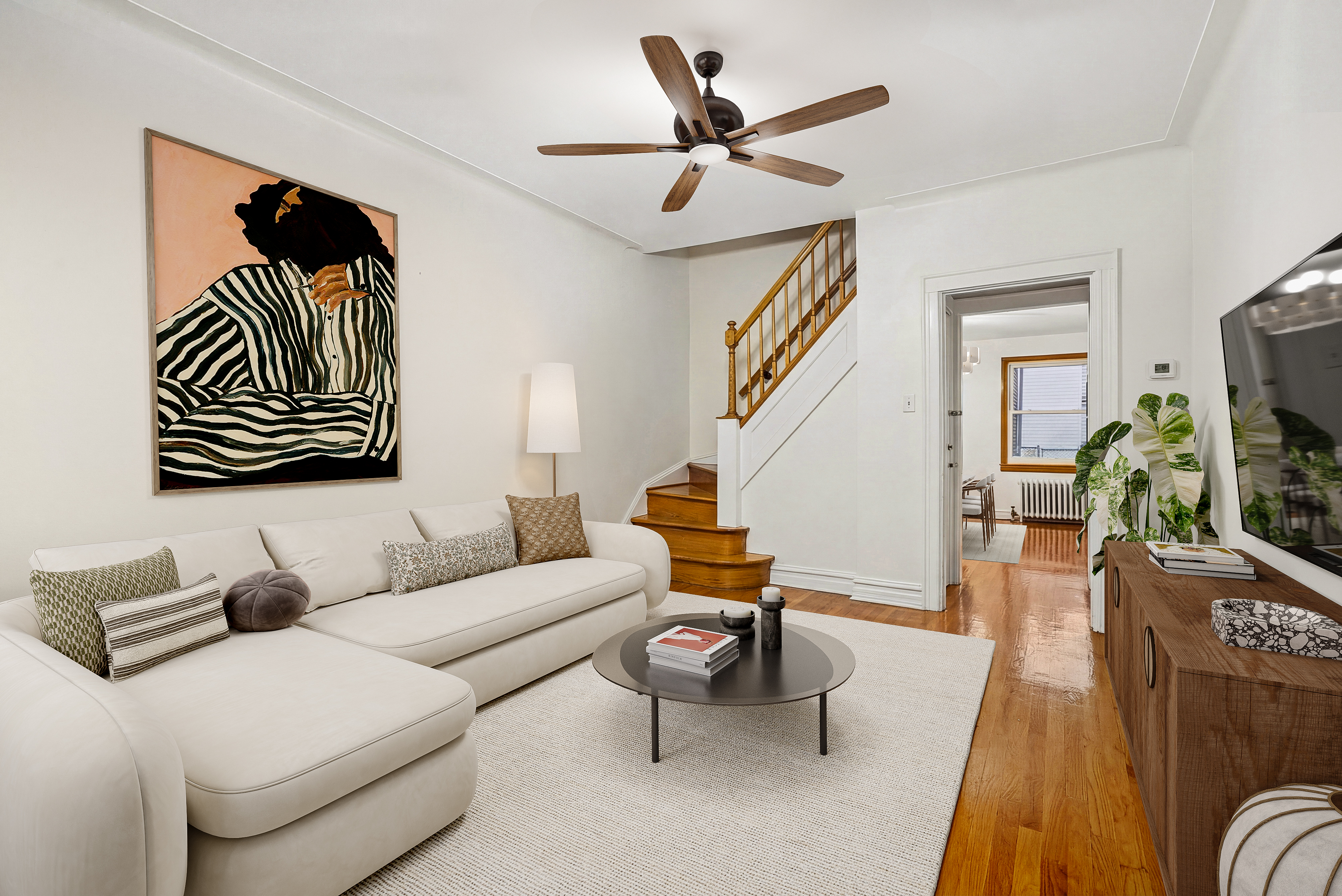 650 88th Street Brooklyn, NY 11228 - Photo 2 of 12 a living room with furniture and a flat screen tv