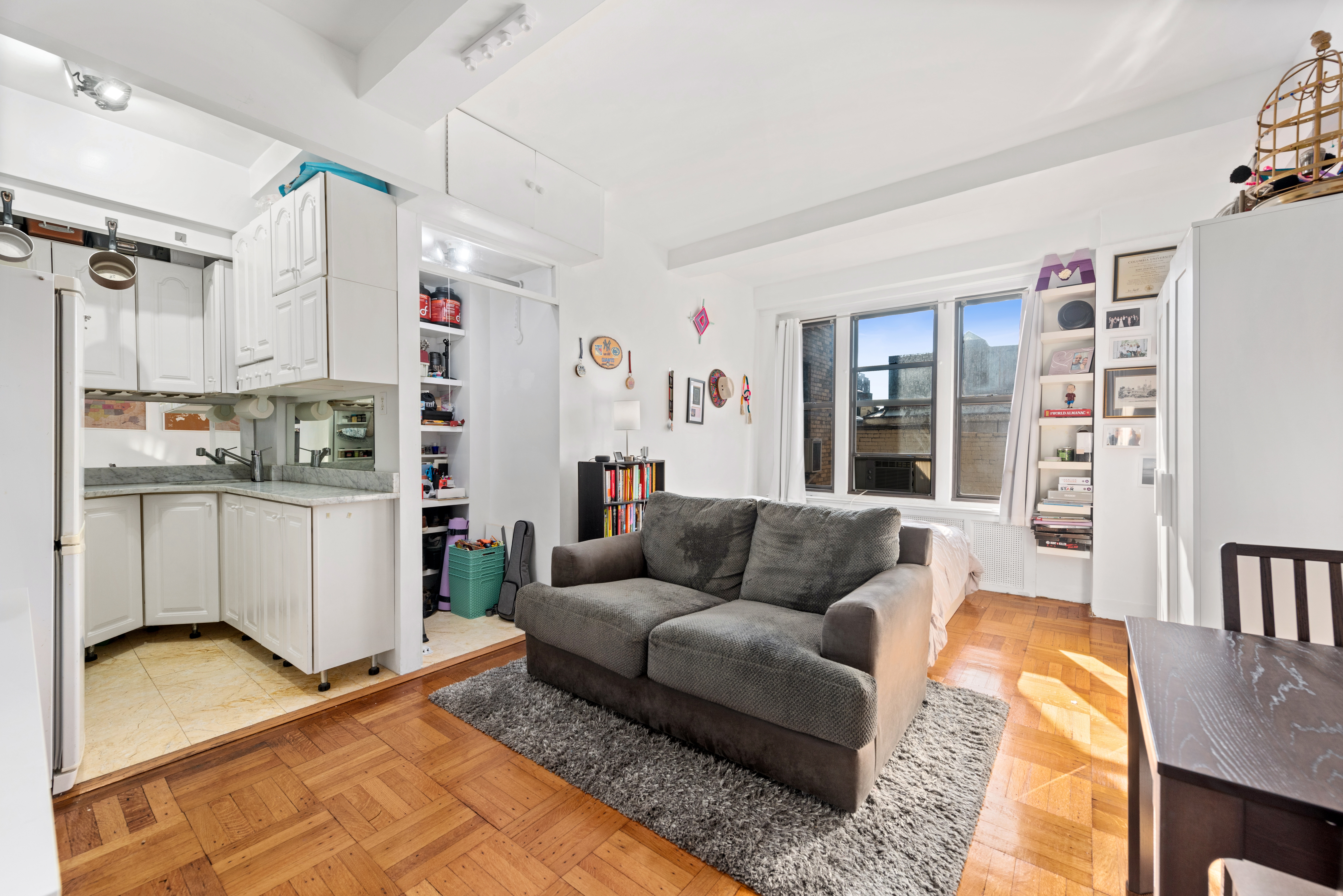 225 Central Park West, Unit 619 Manhattan, NY 10024 - Photo 1 of 6 a living room with furniture and a rug