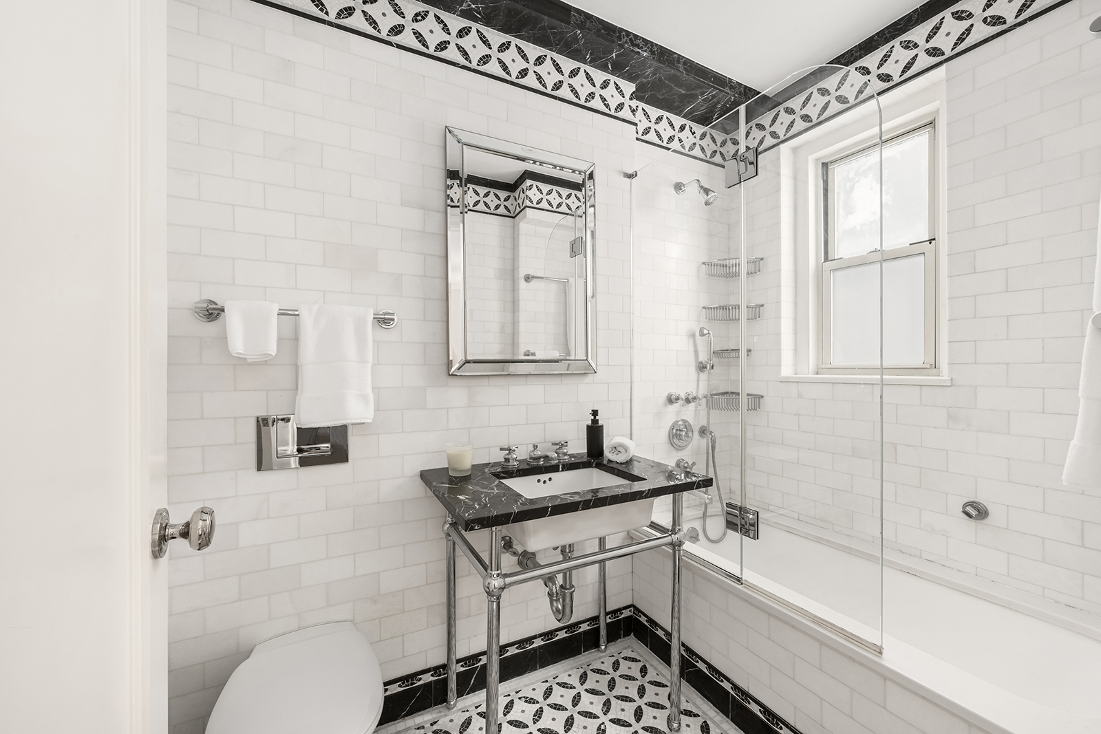 75 Bank Street, Unit 2H Manhattan, NY 10014 - Photo 11 of 18 a bathroom with a bathtub a shower a toilet and a sink