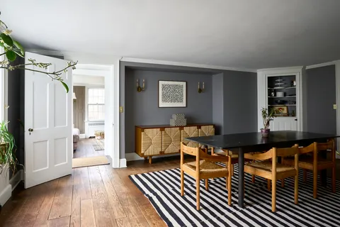 a living room with furniture a rug and a table