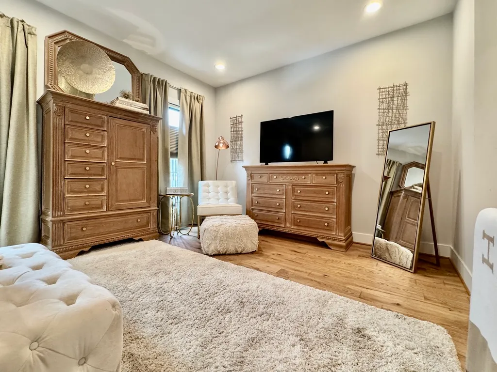 a bedroom with a bed and flat screen tv