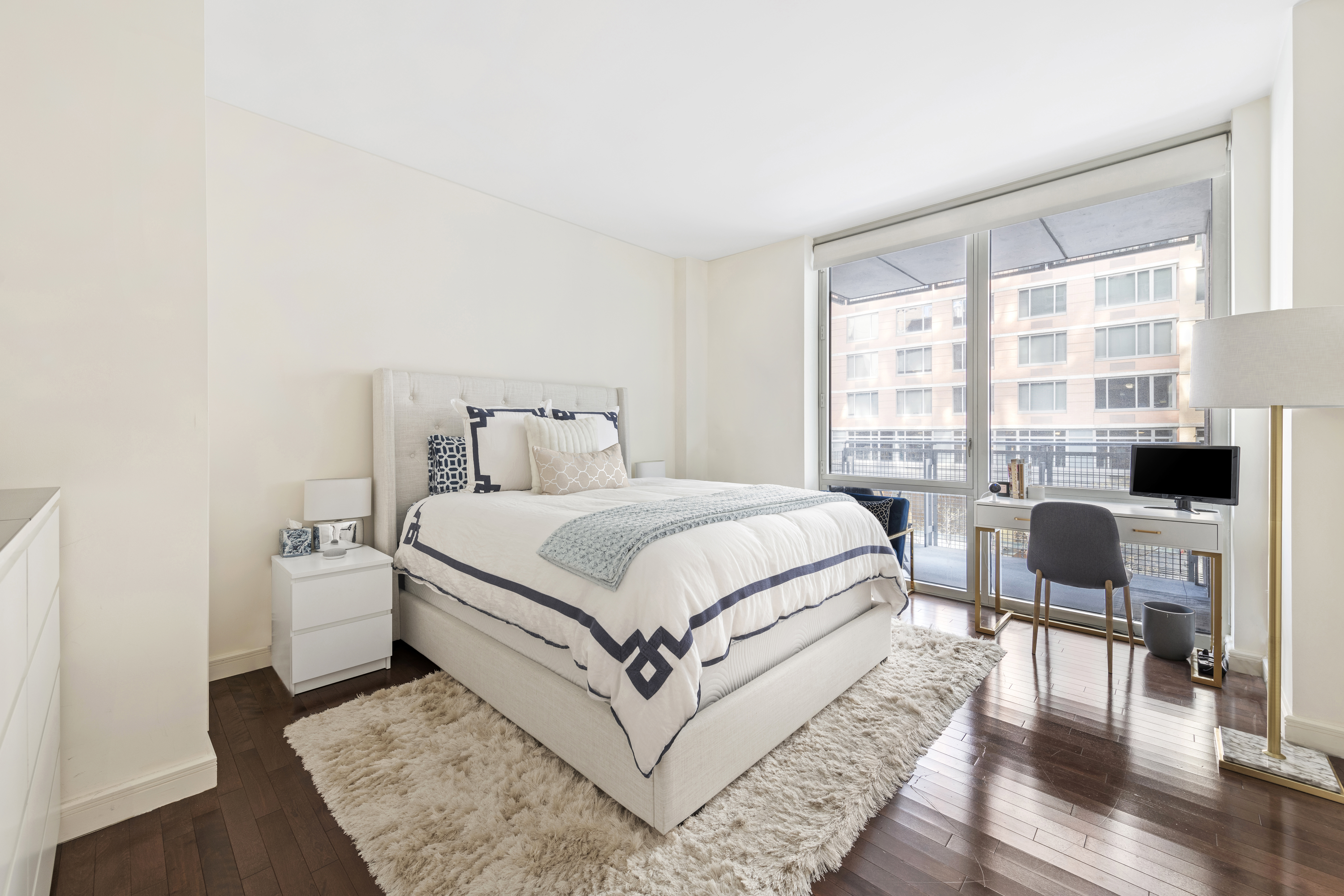 225 East 34th Street, Unit 3G Manhattan, NY 10016 - Photo 3 of 18 a bedroom with a bed and wooden floor