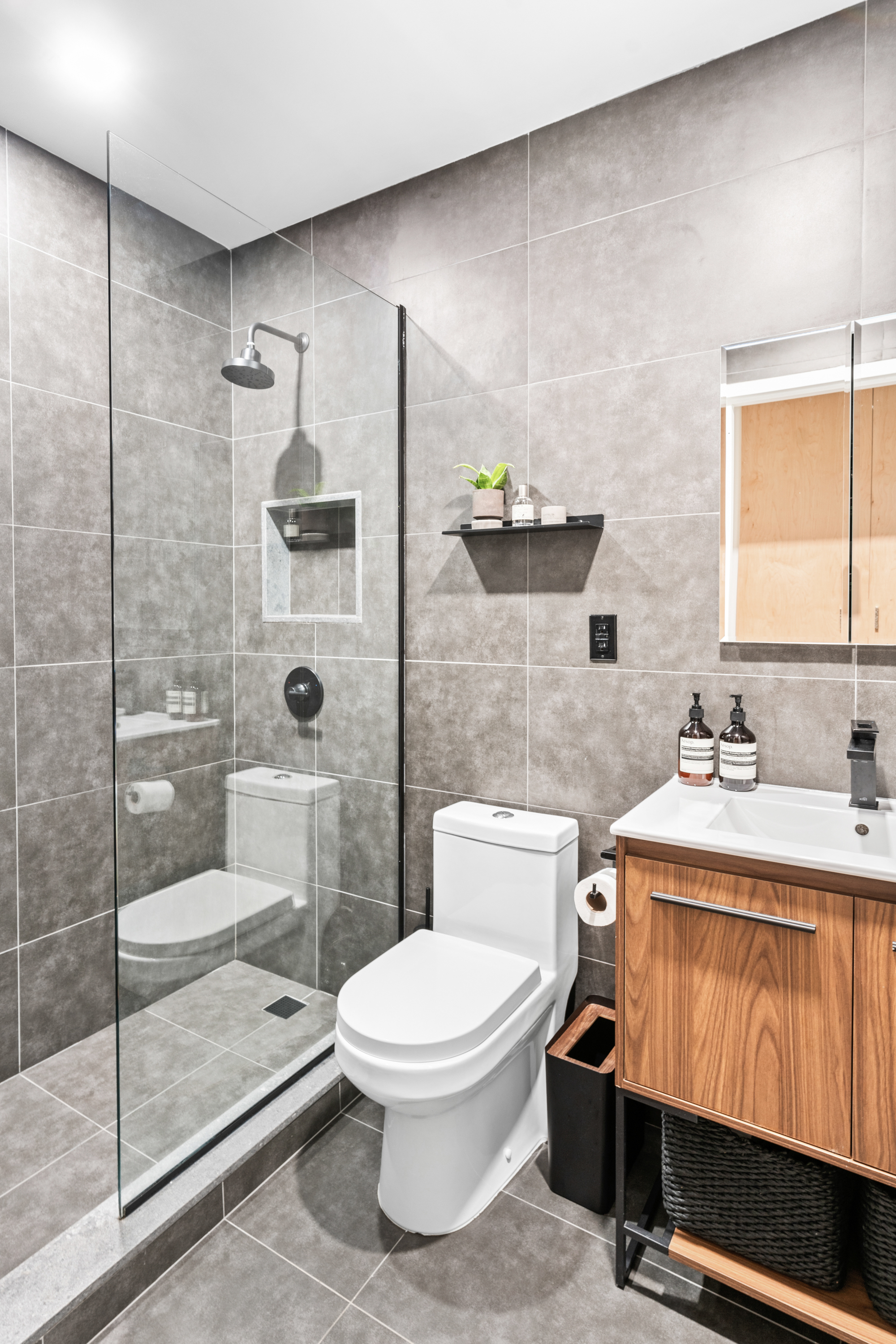 164 Bank Street, Unit 5B Manhattan, NY 10014 - Photo 9 of 11 a bathroom with a toilet sink and shower