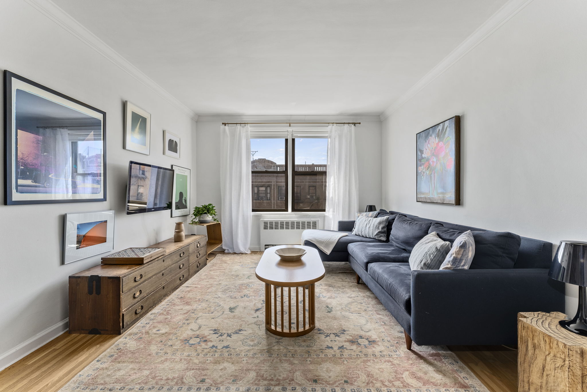 675 Academy Street, Unit 5E Manhattan, NY 10034 - Photo 2 of 10 a living room with furniture and a large window