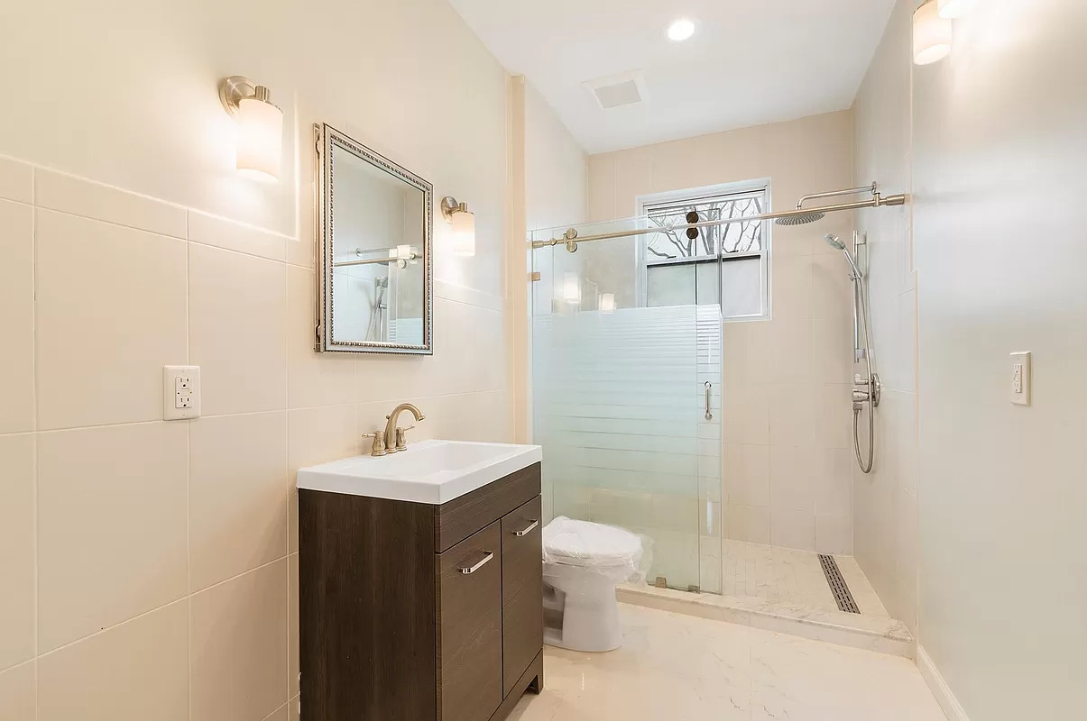 4015 Atlantic Avenue Brooklyn, NY 11224 - Photo 4 of 14 a bathroom with a sink toilet and shower