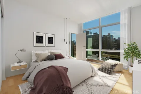a bedroom with a large bed and a flat screen tv