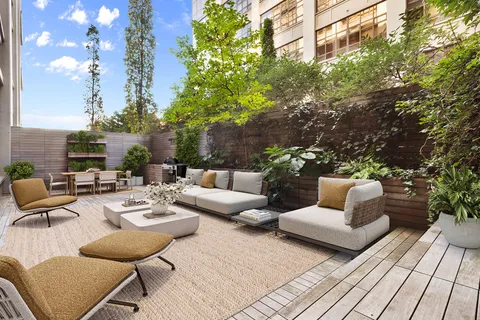 a view of a patio with couches and potted plants
