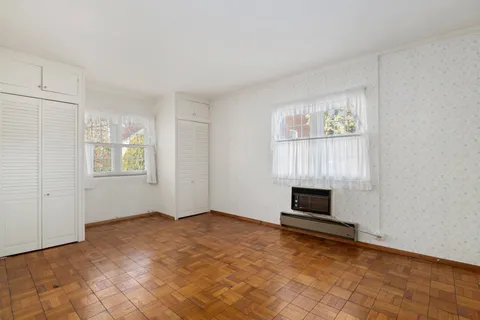 wooden floor fireplace and windows in a room