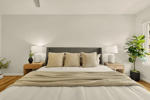 a bedroom with a bed and a chandelier