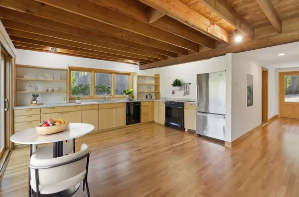 a kitchen with a sink and chairs