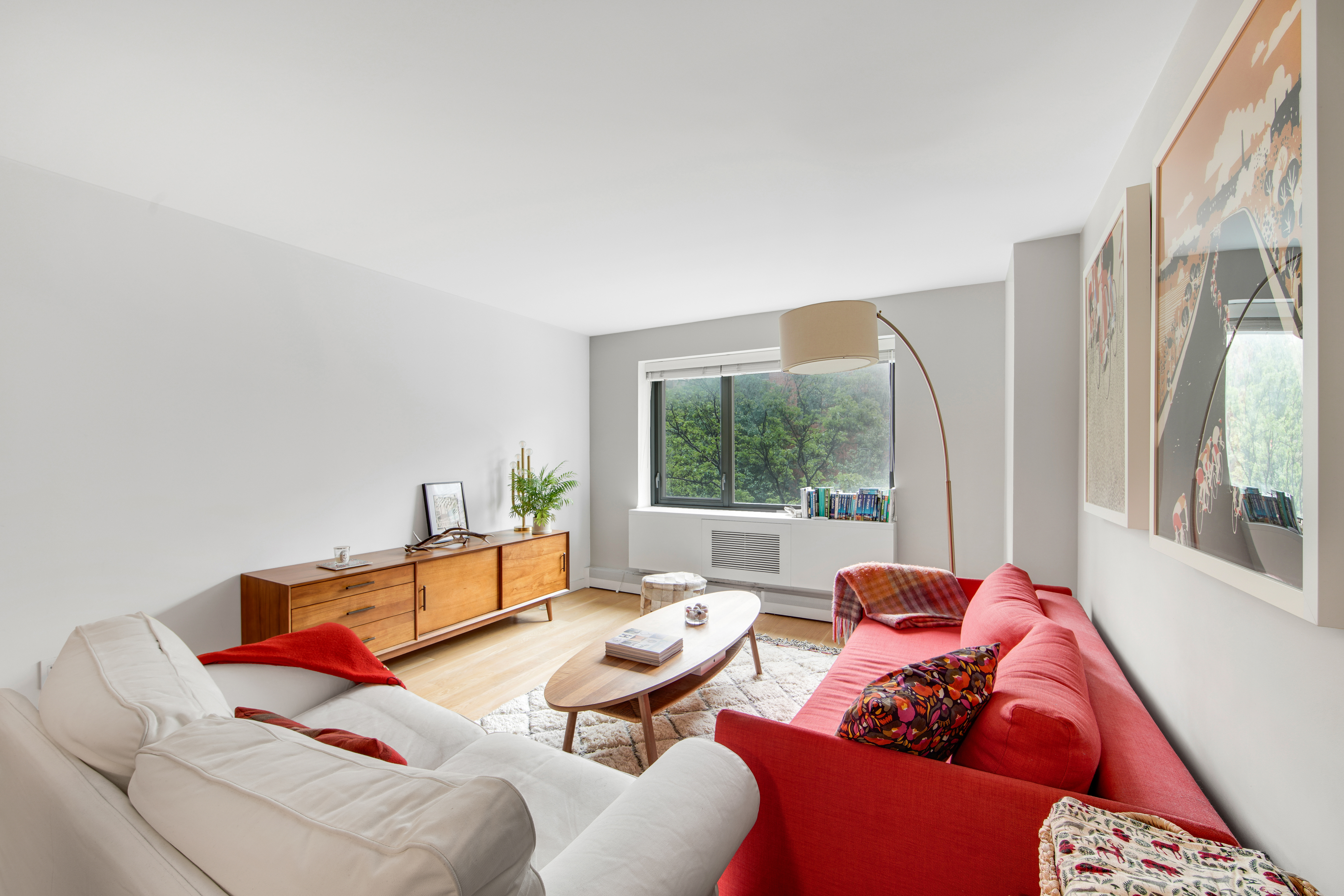 1330 5th Avenue, Unit 3F Manhattan, NY 10026 - Photo 5 of 16 a living room with furniture and a large window
