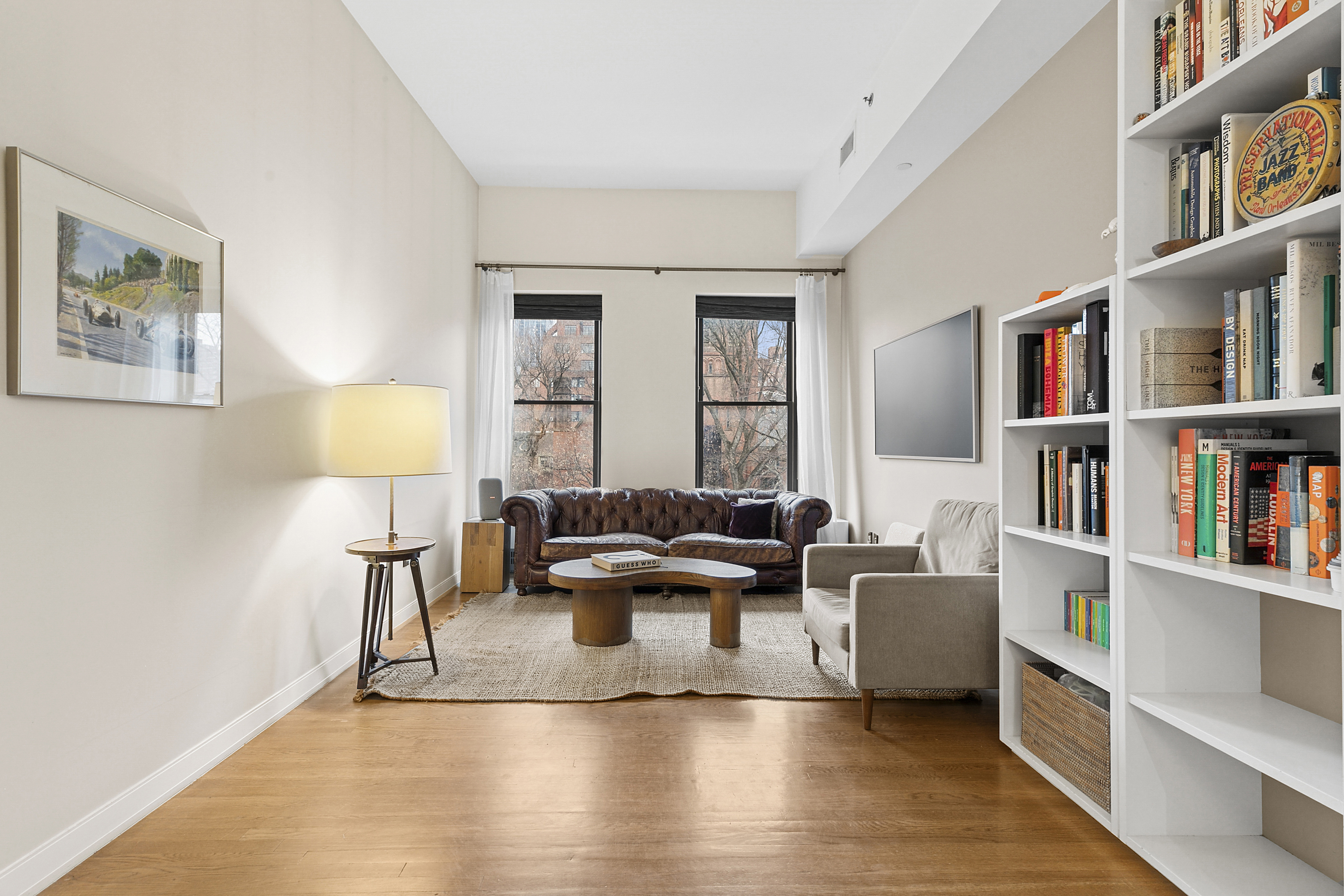 422 West 20th Street, Unit 5A Manhattan, NY 10011 - Photo 3 of 14 a living room with furniture and a book shelf