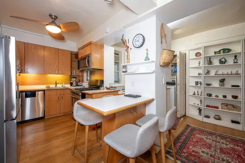 a view of a kitchen with a table and chairs