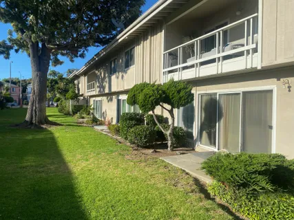 a view of a house with backyard and sitting area