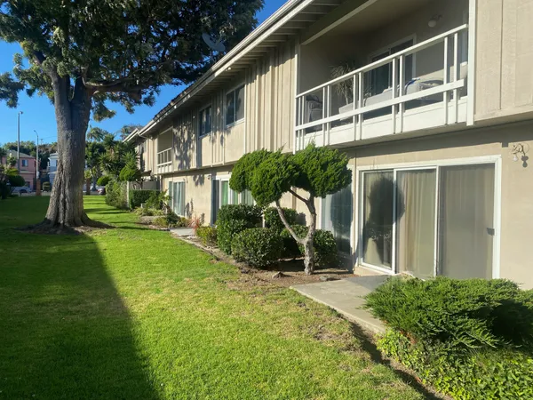 a view of a house with backyard and sitting area