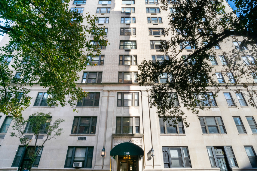 1160 Park Avenue, Unit 8C Manhattan, NY 10128 - Photo 17 of 18 a front view of a multi story building with a yard