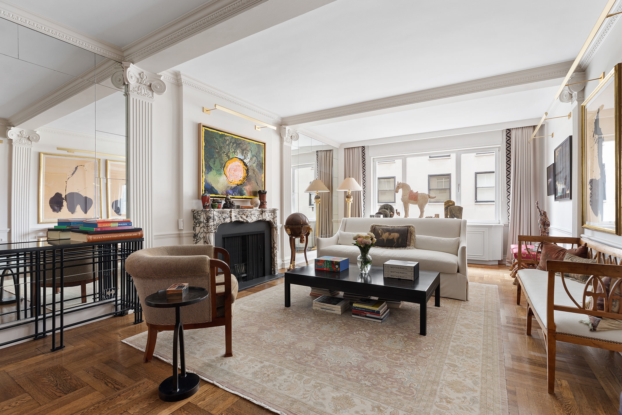 930 5th Avenue, Unit 11D Manhattan, NY 10021 - Photo 2 of 11 a living room with furniture and a potted plant