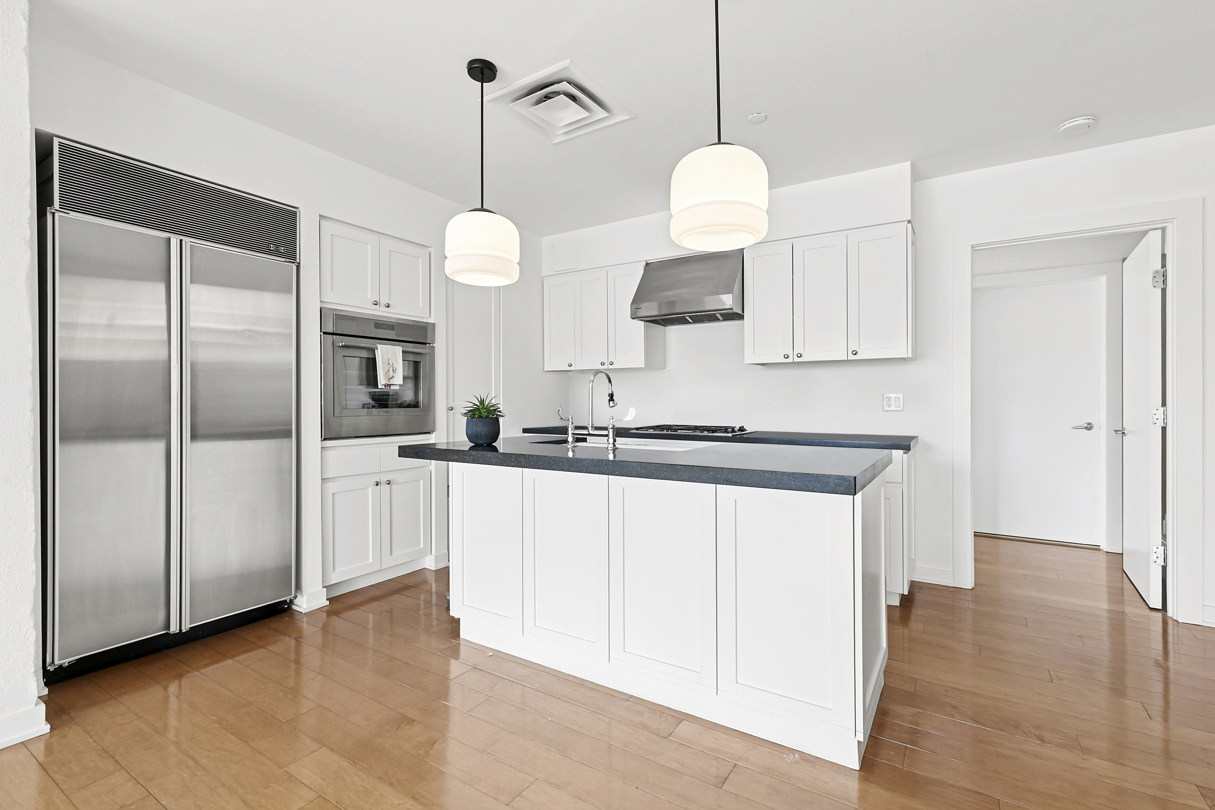 28 Laight Street, Unit 3B Manhattan, NY 10013 - Photo 6 of 11 a kitchen with a refrigerator a sink and cabinets