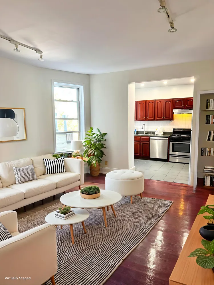 a living room with furniture and wooden floor