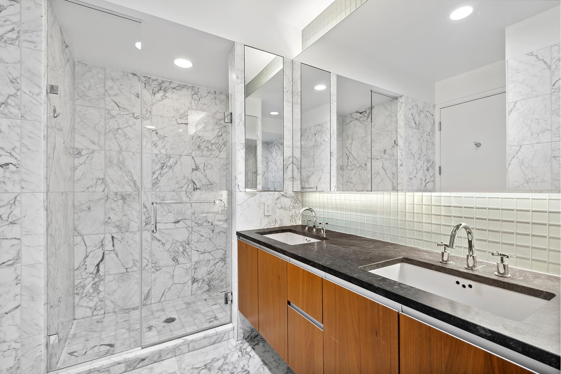 311 West Broadway, Unit 5G Manhattan, NY 10013 - Photo 5 of 14 a bathroom with a sink and a mirror