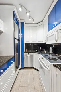 a kitchen with stainless steel appliances granite countertop a refrigerator and a stove top oven
