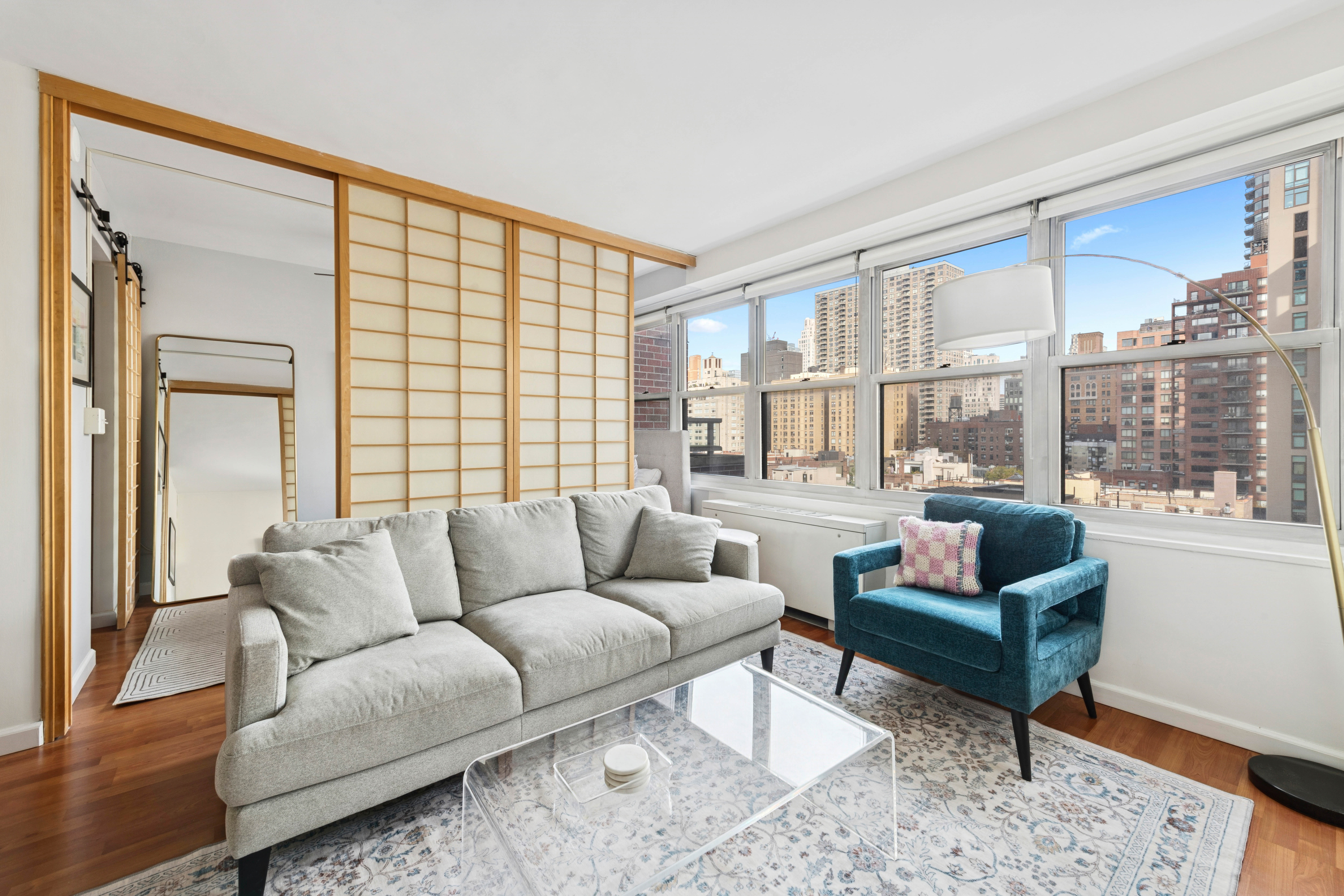 363 East 76th Street, Unit 11K Manhattan, NY 10021 - Photo 4 of 16 a living room with furniture and a large window