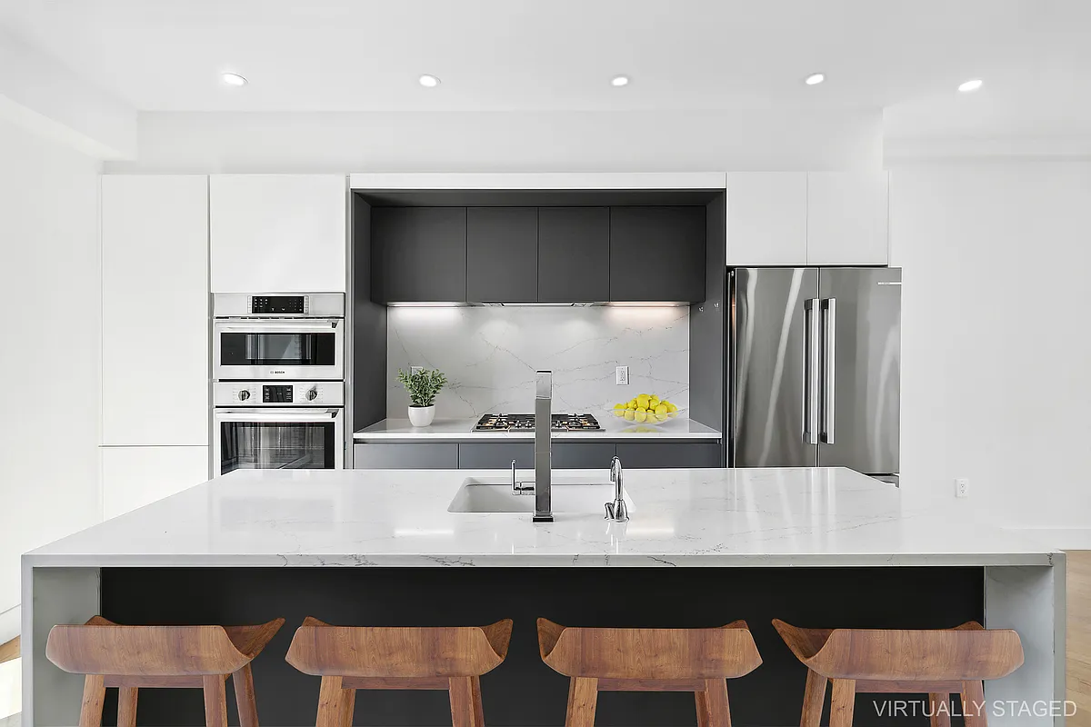 483 Hart Street, Unit PH Brooklyn, NY 11221 - Photo 3 of 17 a kitchen with a sink a table and chairs