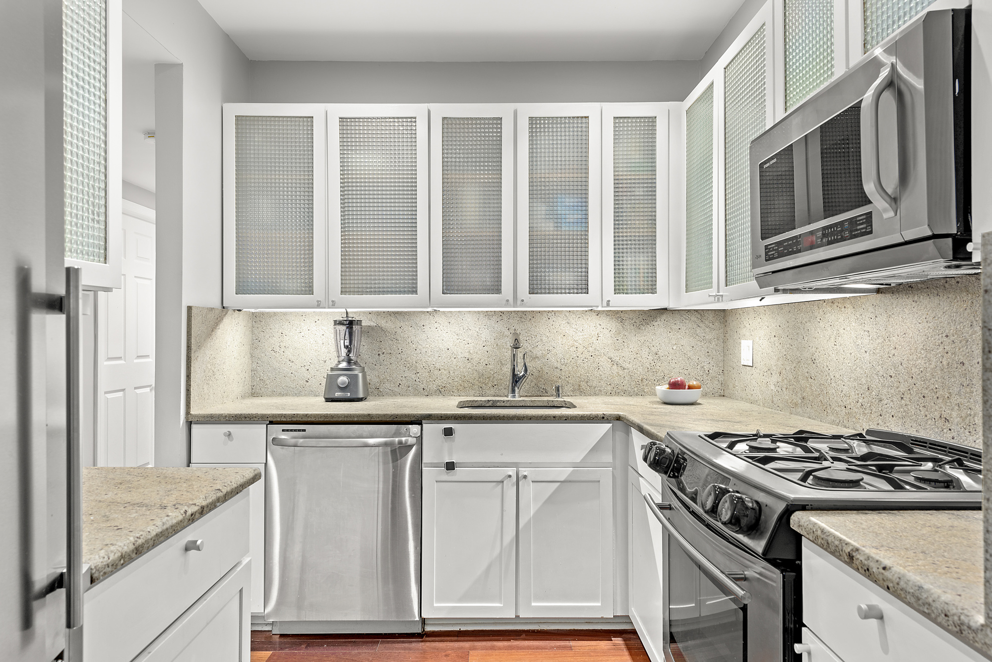 163 St Nicholas Avenue, Unit 2J Manhattan, NY 10026 - Photo 3 of 13 a kitchen with stainless steel appliances granite countertop a stove and a microwave