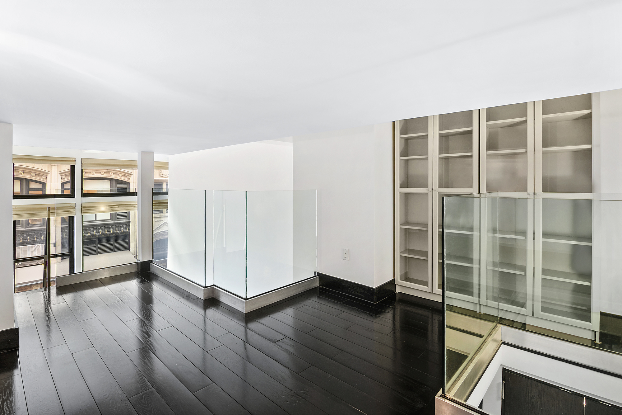 254 Park Avenue South, Unit 3G Manhattan, NY 10010 - Photo 2 of 12 a view of a kitchen with wooden floor and windows
