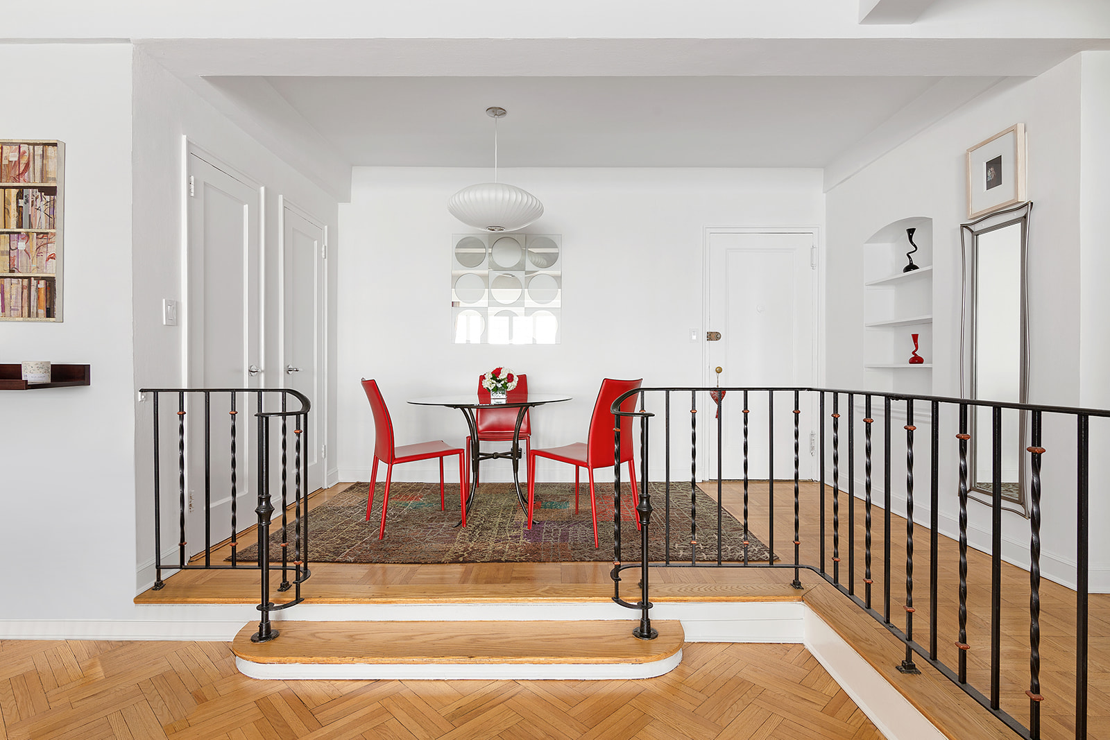 333 West 57th Street, Unit 8B Manhattan, NY 10019 - Photo 2 of 8 a view of a hallway with a dining table and chandelier