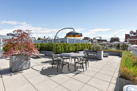 a view of a terrace with furniture and garden