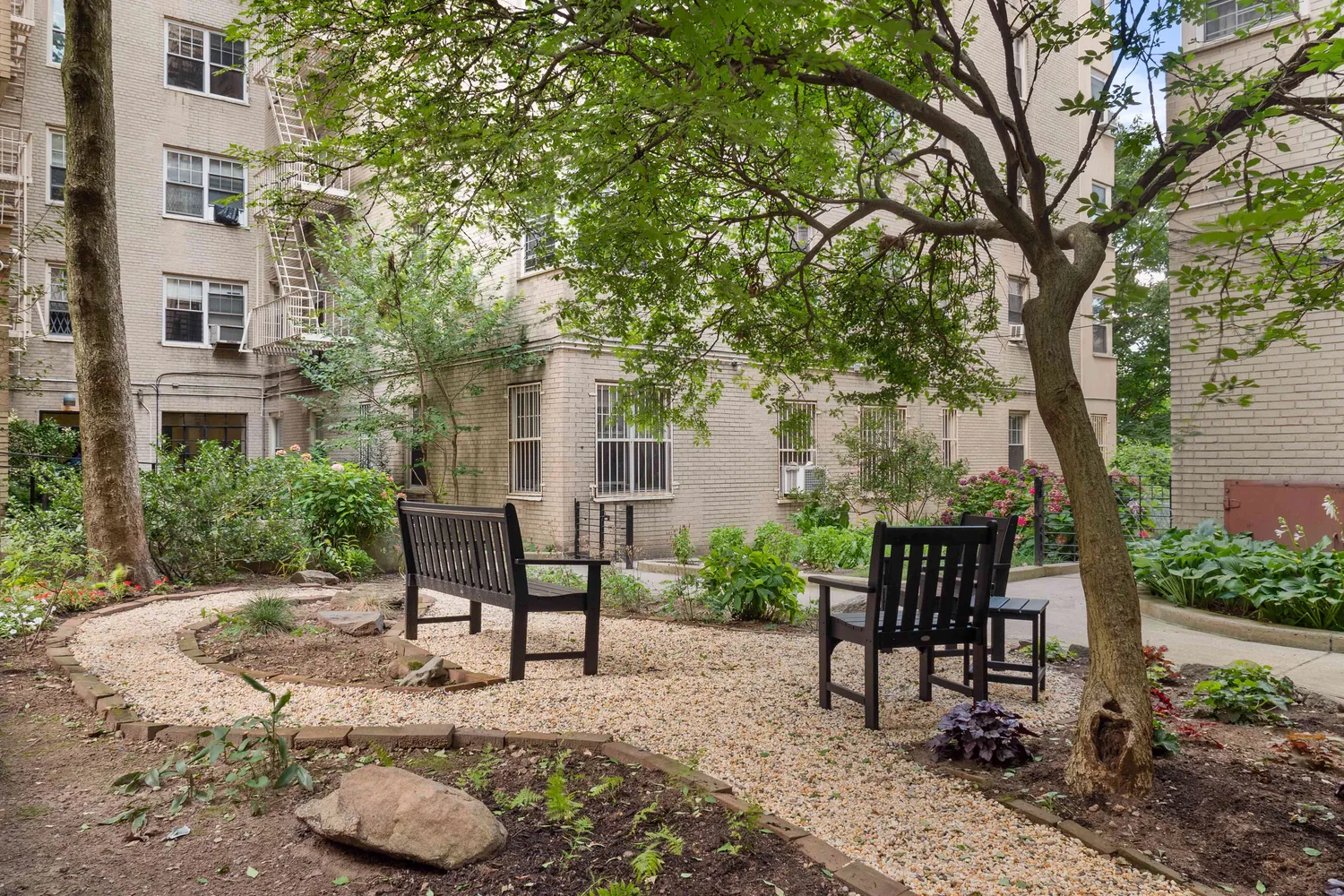 a view of a chairs and table in backyard