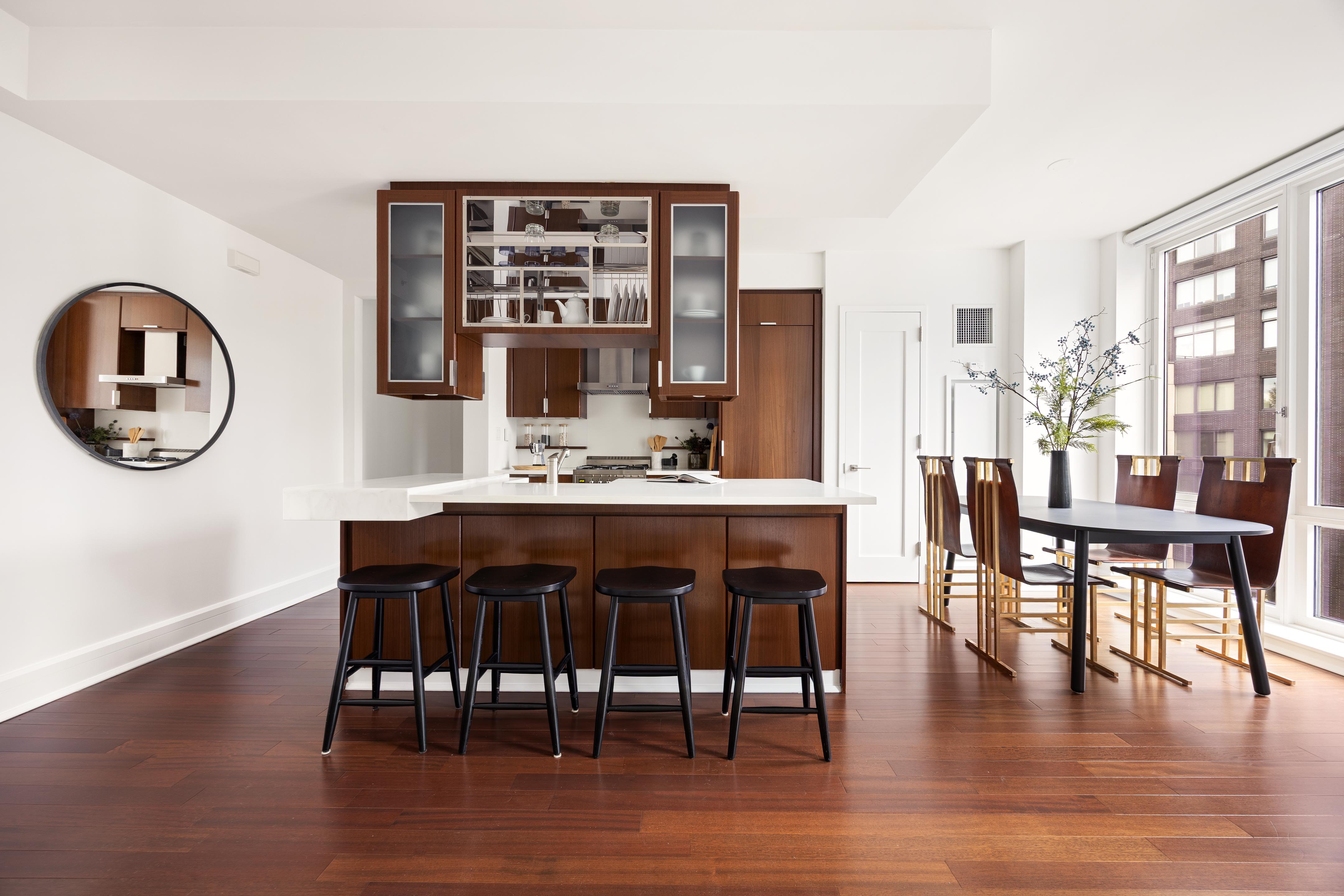 60 Riverside Boulevard, Unit 1508 Manhattan, NY 10069 - Photo 4 of 14 a dining room with wooden floor a chandelier a wooden table and chairs