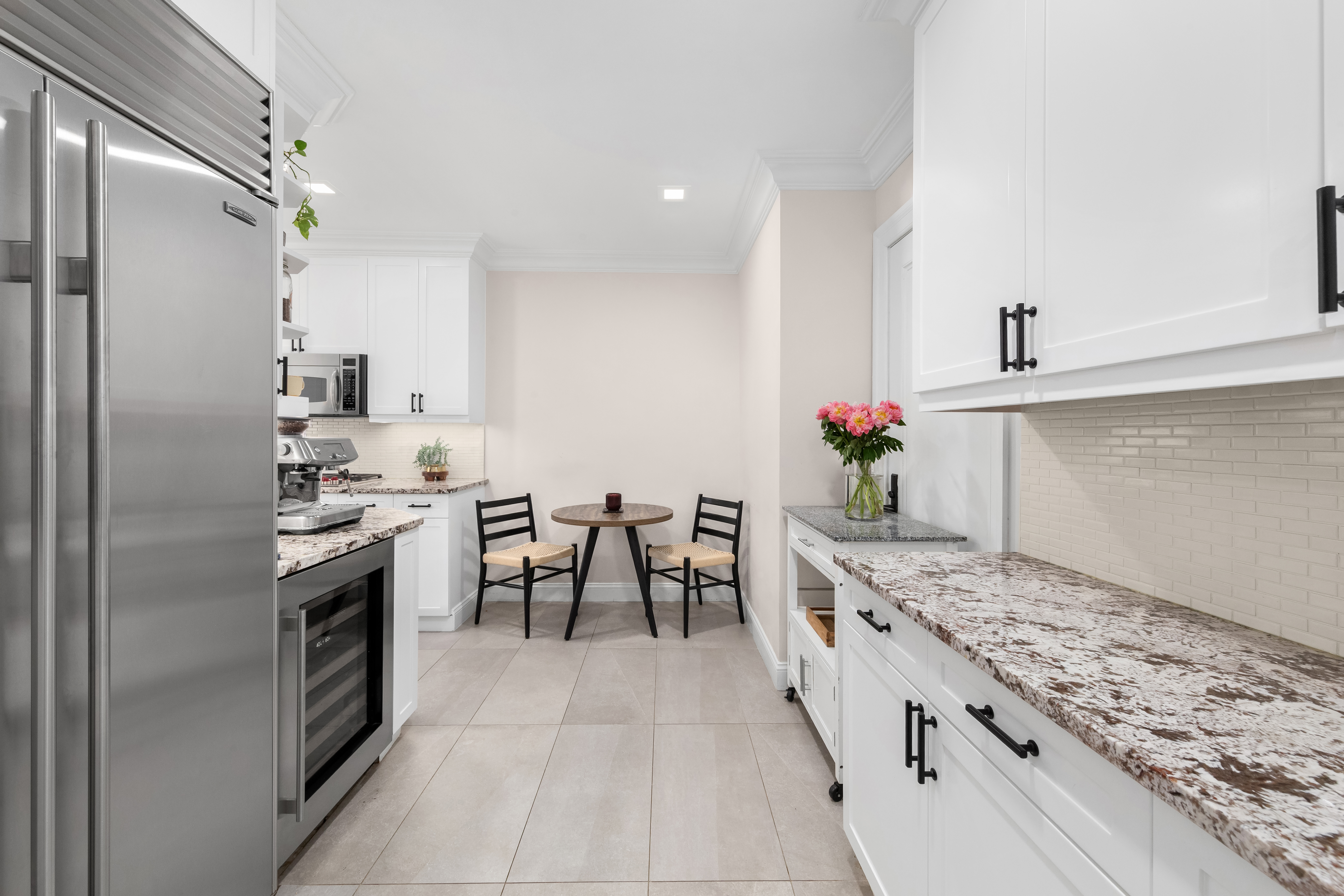 905 West End Avenue, Unit 81 Manhattan, NY 10025 - Photo 5 of 14 a kitchen with kitchen island granite countertop lots of counter top space and stainless steel appliances
